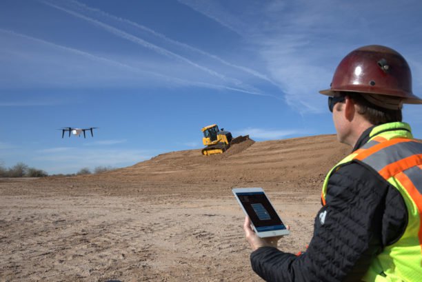 Construction worker flying a drone