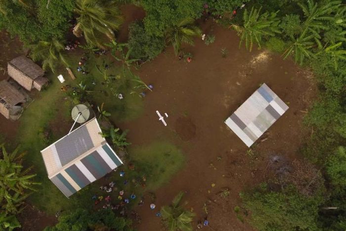 A drone comes in to land at a small village in Vanuatu.