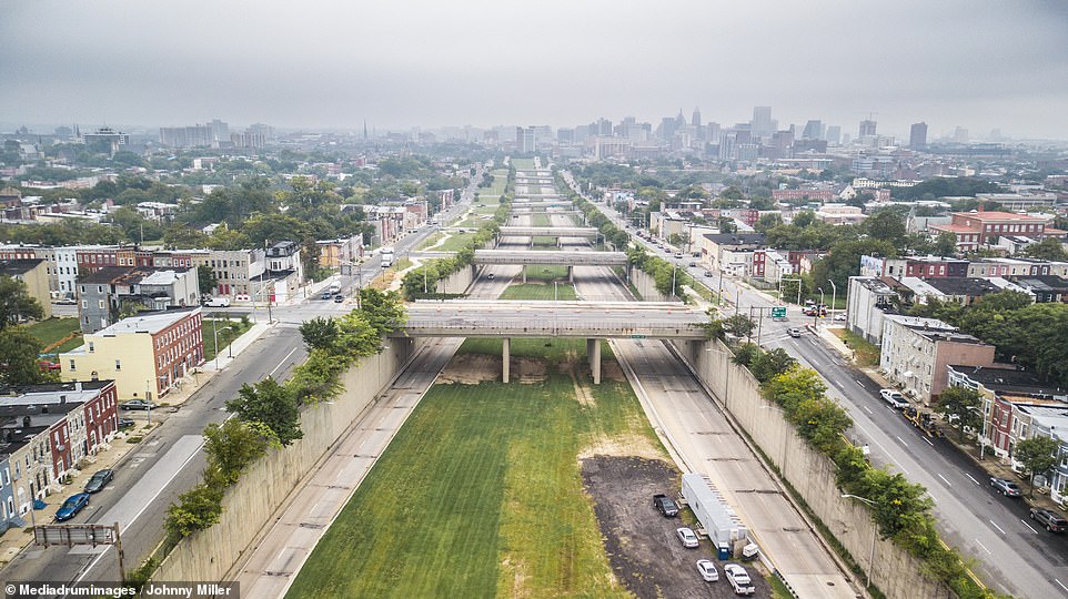 He also turns his camera to crime-ridden Baltimore where entire blocks have been left to collapse into ruin and the 'Road to Nowhere' highway (pictured) which displaced thousands of the city's poorest residents but was never completed 