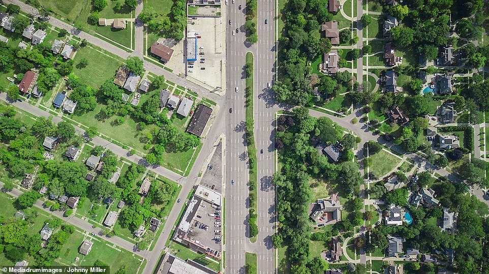 The stark drone photos show areas of gross inequality across LA, Detroit, Baltimore and San Francisco among others. This picture of Detroit's Woodward Avenue shows the sharp contrast between the large homes of the wealthy, many with pools and big backyards on one side, compared to the much more modest houses on the left