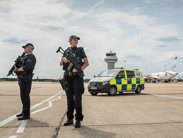 Sussex Police are pictured at Gatwick Airport. Detectives are no nearer to tracking down the culprit who grounded 760 flights at Britain¿s second biggest airport