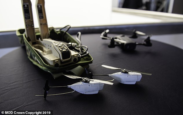 A selection of mini drones UAV's (Unmanned Aerial Vehicle), used by the UK armed forces which includes the black hornet (pictured -  bottom). The Defence Secretary said that some of the robotic kit 'is already set to deploy to Estonia, Afghanistan and Iraq by the end of the year'