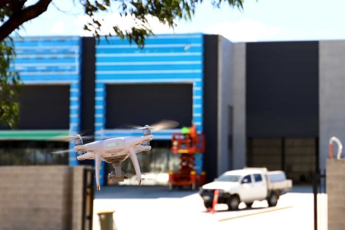 A drone flies outside Project Wing's hangar.