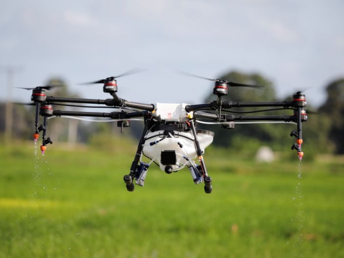 A customized DJI Agras MG-1S drone sprays water over a rice field during a pilots training flight, as part of a test in using drone technology in the fight against malaria, near Zanzibar City, on the island of Zanzibar, Tanzania, October 31, 2019. REUTERS/Baz Ratner