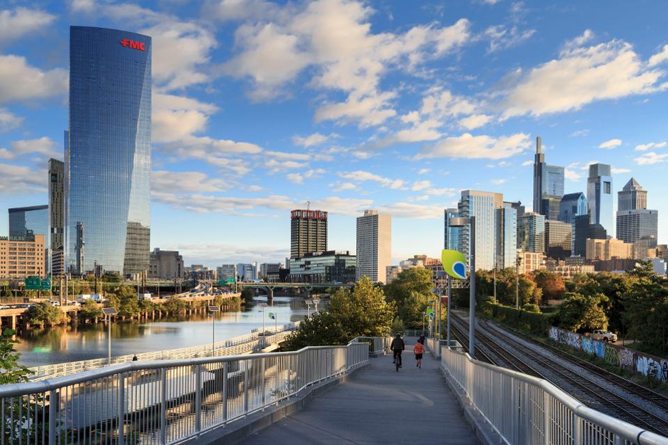 Philadelphia Skyline with Schuylkill River Park Boardwalk in Autumn with Bikers and Joggers, Philadelphia, Pennsylvania, USA