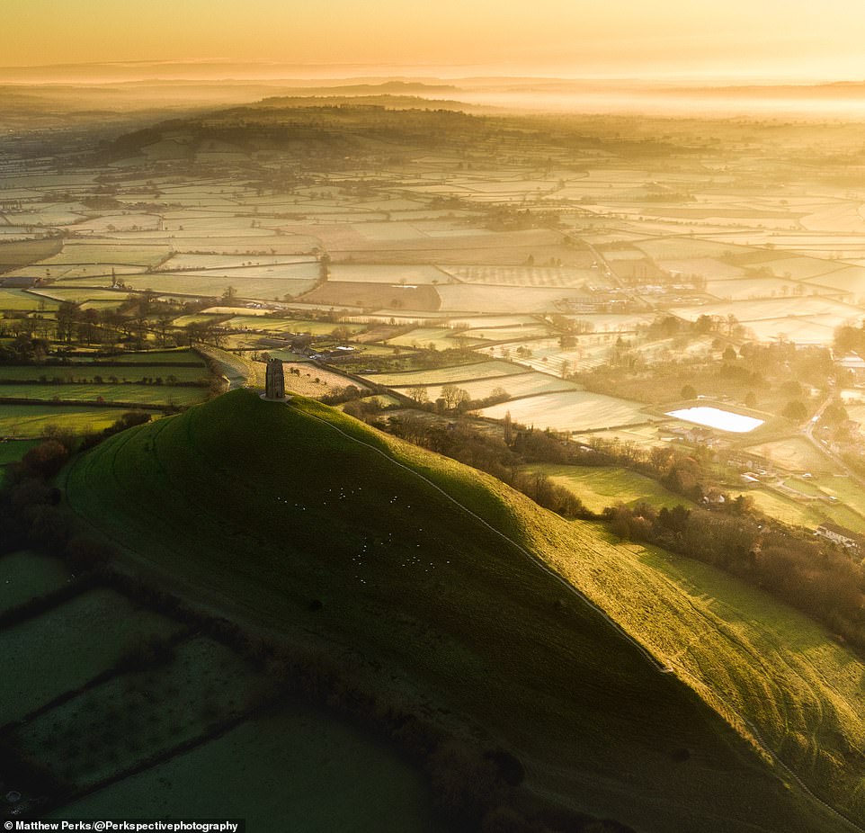 A stunning shot of the iconic Glastonbury Tor. It's a hill, topped by St Michael's Tower, around which mysteries and legends have swirled for centuries. It's said that Jesus came here as a boy, that the fairy realm of Annwn lies beneath and that the Holy Grail was brought here by Jesus's uncle, Joseph of Arimathea