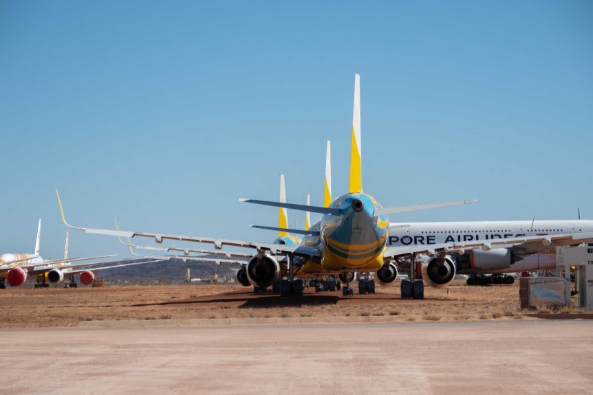 Large planes with different logos sit at Alice Springs airport facility.
