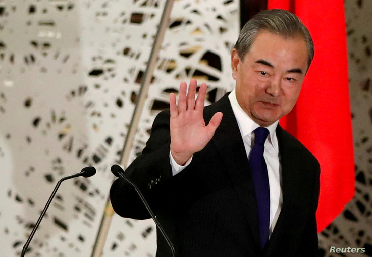 FILE PHOTO: China's State Councillor and Foreign Minister Wang Yi waves as he leaves a news conference in Tokyo, Japan,…