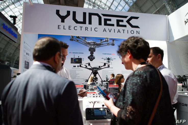 Visitors look at the products on the Yuneec electric aviation stand, during the 'Security and Counter Terror Expo' at the...