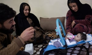 Zeri, the daughter of Mukhlis Adam, is surrounded by her aunts and uncles in the family’s living room