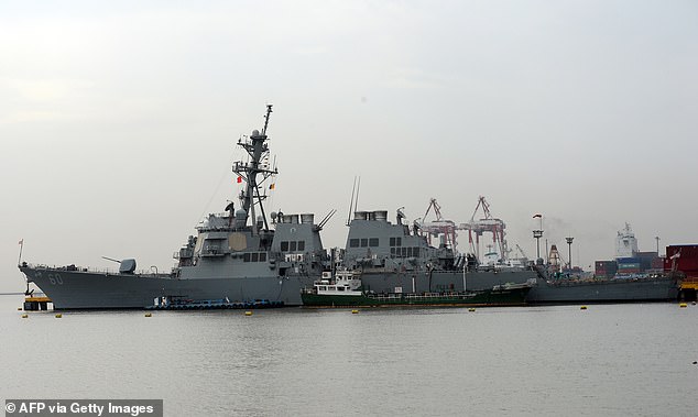 The USS Paul Hamilton (pictured) had a swarm of 16 drones follow it on July 17