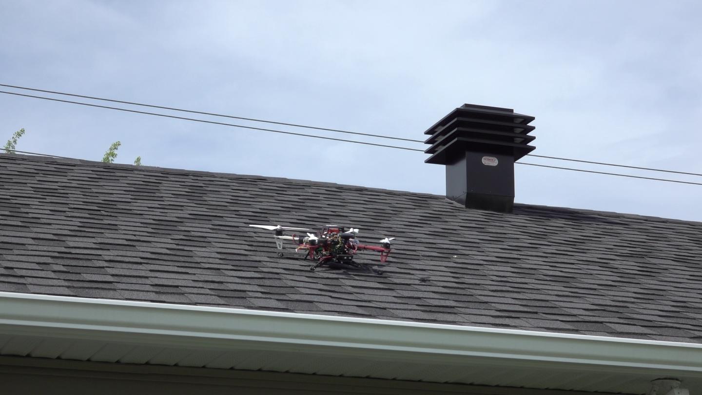 A drone nestles safely on a steep rooftop