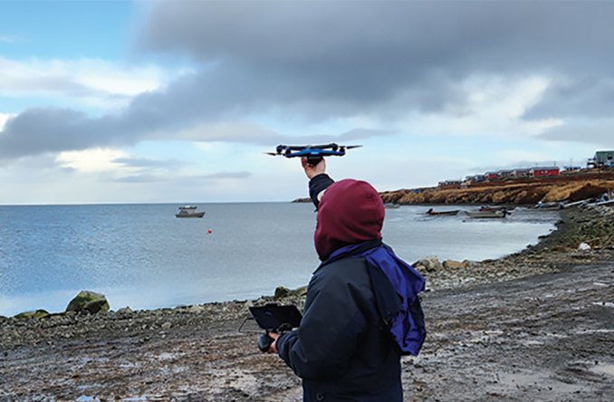 Pilot Katie Daniels, with the Association of Village Council Presidents, launches a Skydio drone over the community of Mertarvik on Oct. 20, 2022. Photo by Mike DeLue