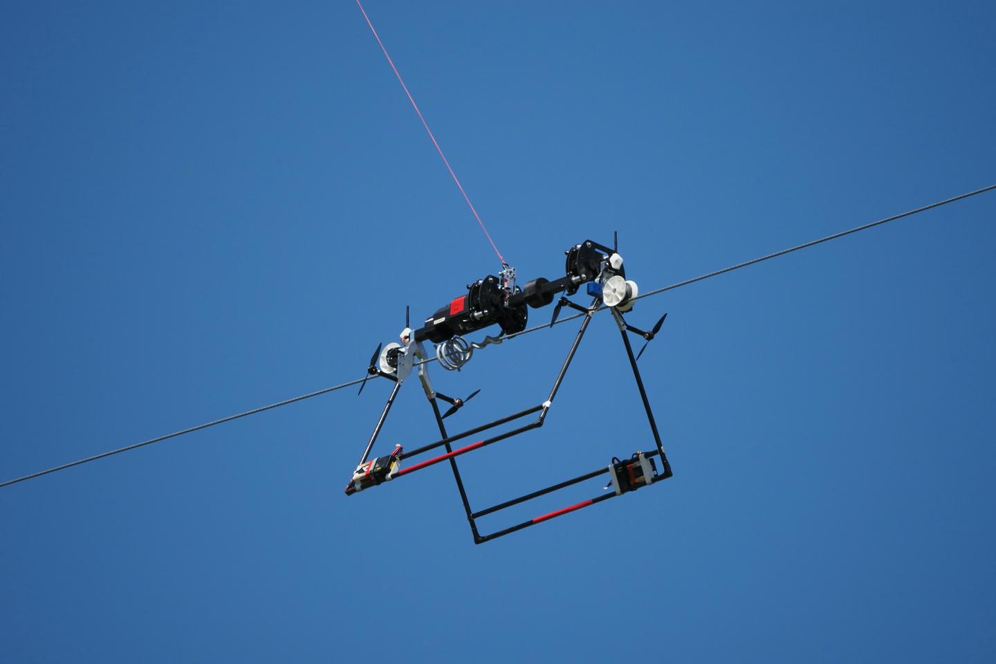Although the Mini LineFly robot is attached to the drone via a tether, the two devices are independently operated