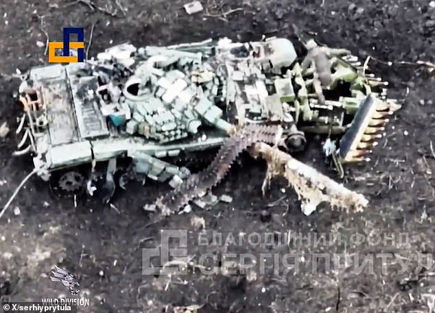 In a hellish and war-torn Ukraine, a Russian soldier is spotted by a suicide down cowering under the main gun of a destroyed tank