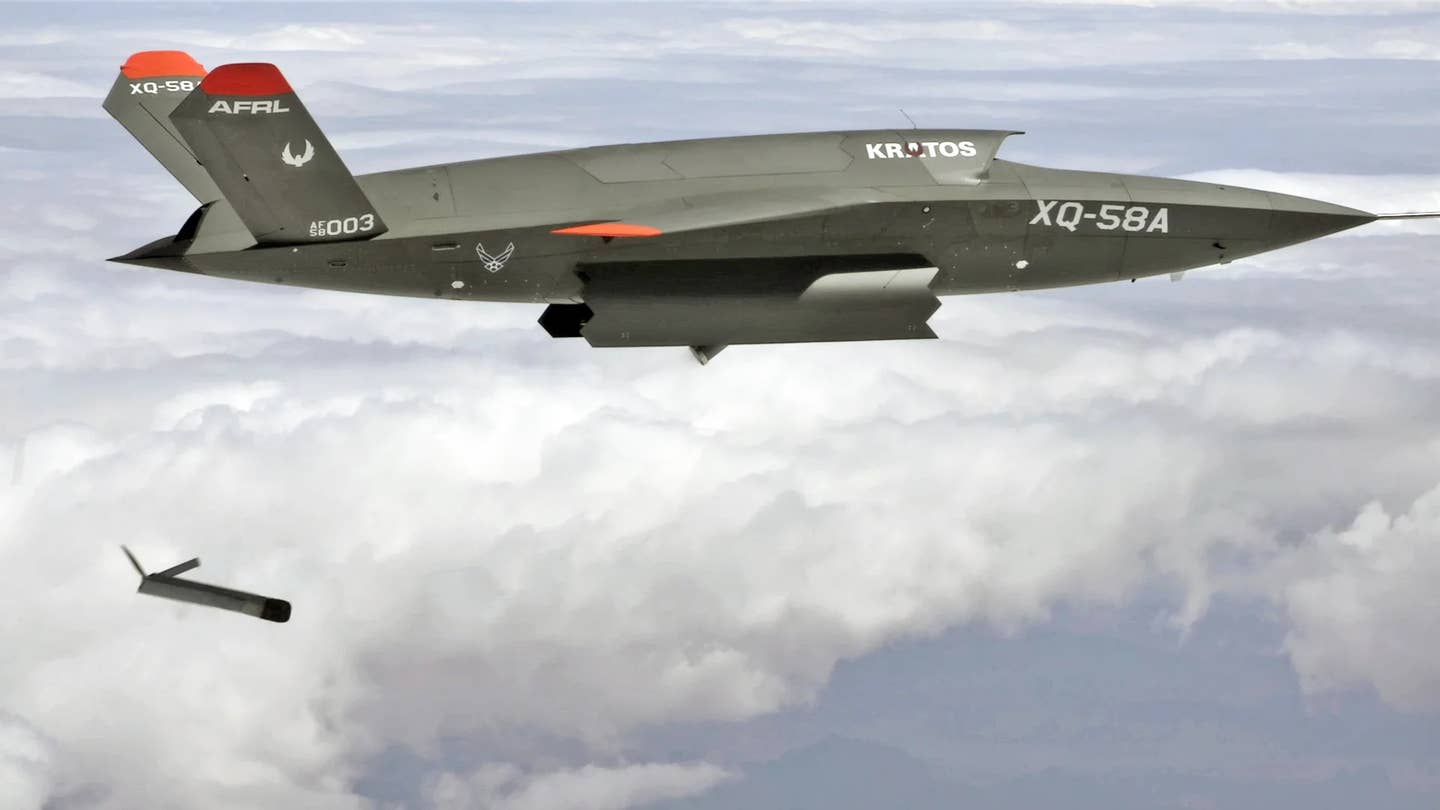 An Air Force XQ-58A releases a smaller ALTIUS 600 drone from its internal payload bay during a test in 2021. <em>USAF</em>