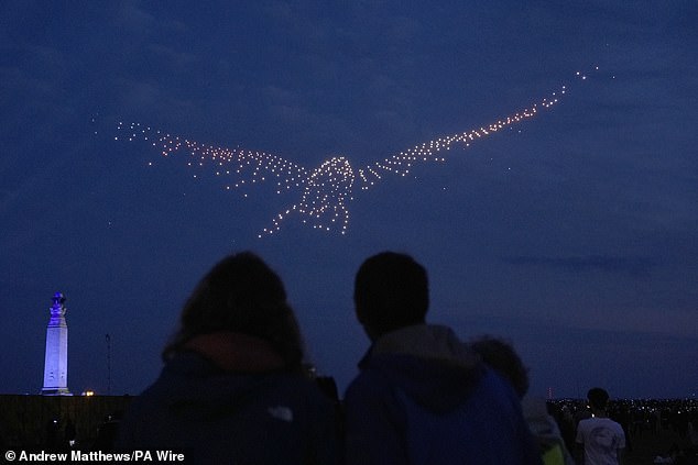 Drones make a bird shape during a drone display telling the story of D-Day