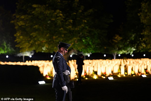 The D-Day ceremonies on June 6 this year mark the 80th anniversary since the launch of 'Operation Overlord'. A British soldier stands in front of the lit up graves
