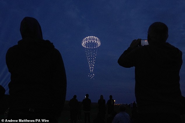 Drones make a parachute during a drone display telling the story of D-Day