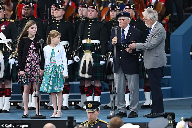 D-Day veteran Eric Bateman speaks alongside his son-in-law Keith and great grand daughters Annabel and Imogen