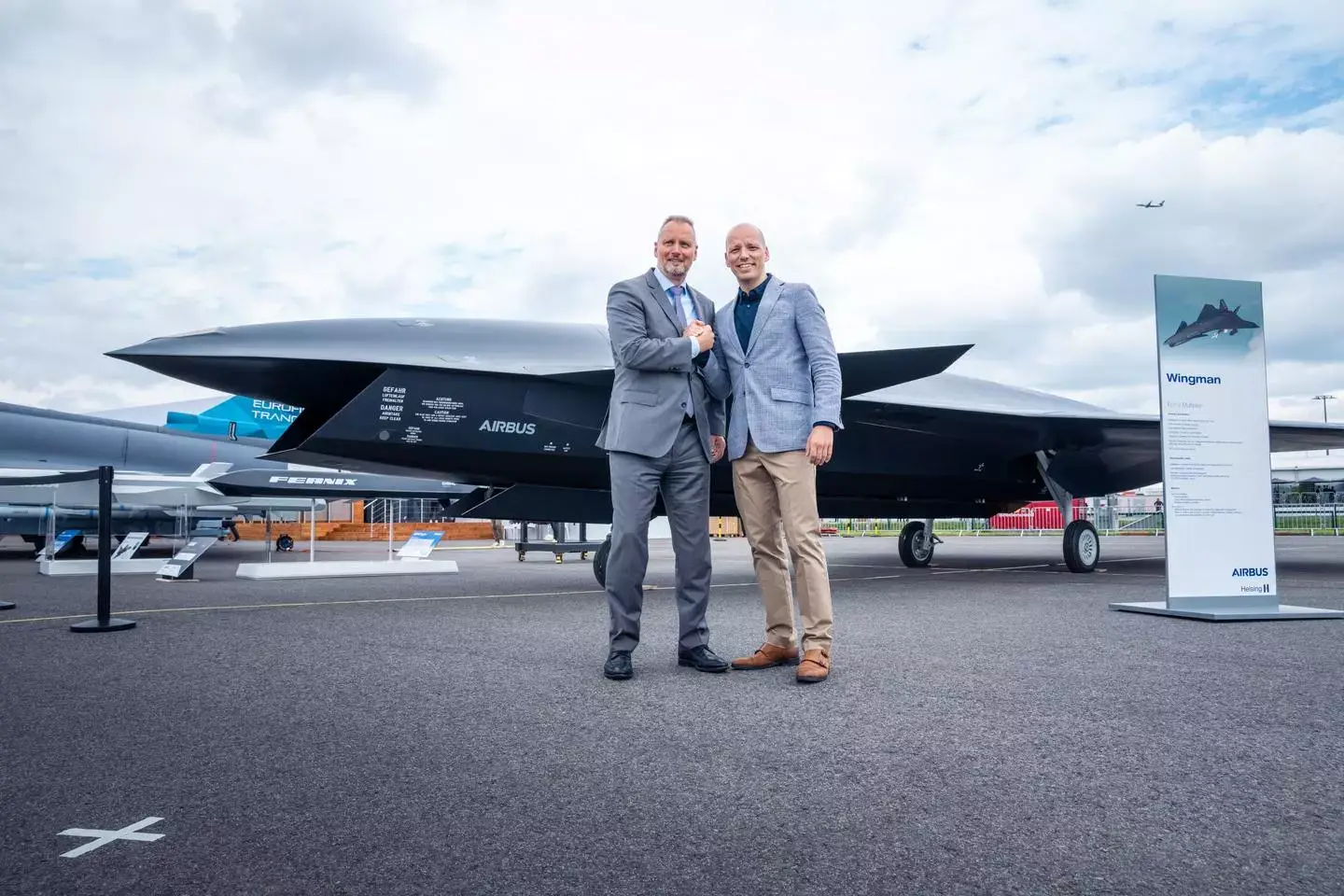 Michael Schoellhorn, CEO at Airbus Defence and Space (on the left), and Gundbert Scherf, Co-CEO at Helsing, in front of the Airbus Wingman model. <em>Airbus</em>
